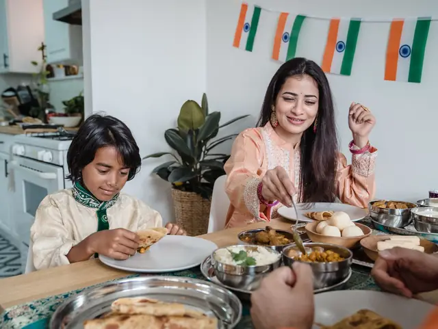 An Indian mother and son eating a home-cooked meal together